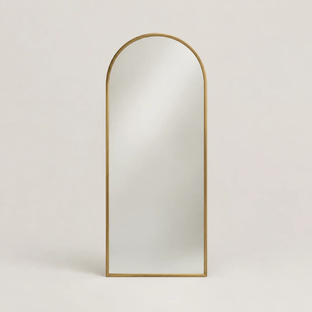 Arched wall mirror with a slim brushed brass frame